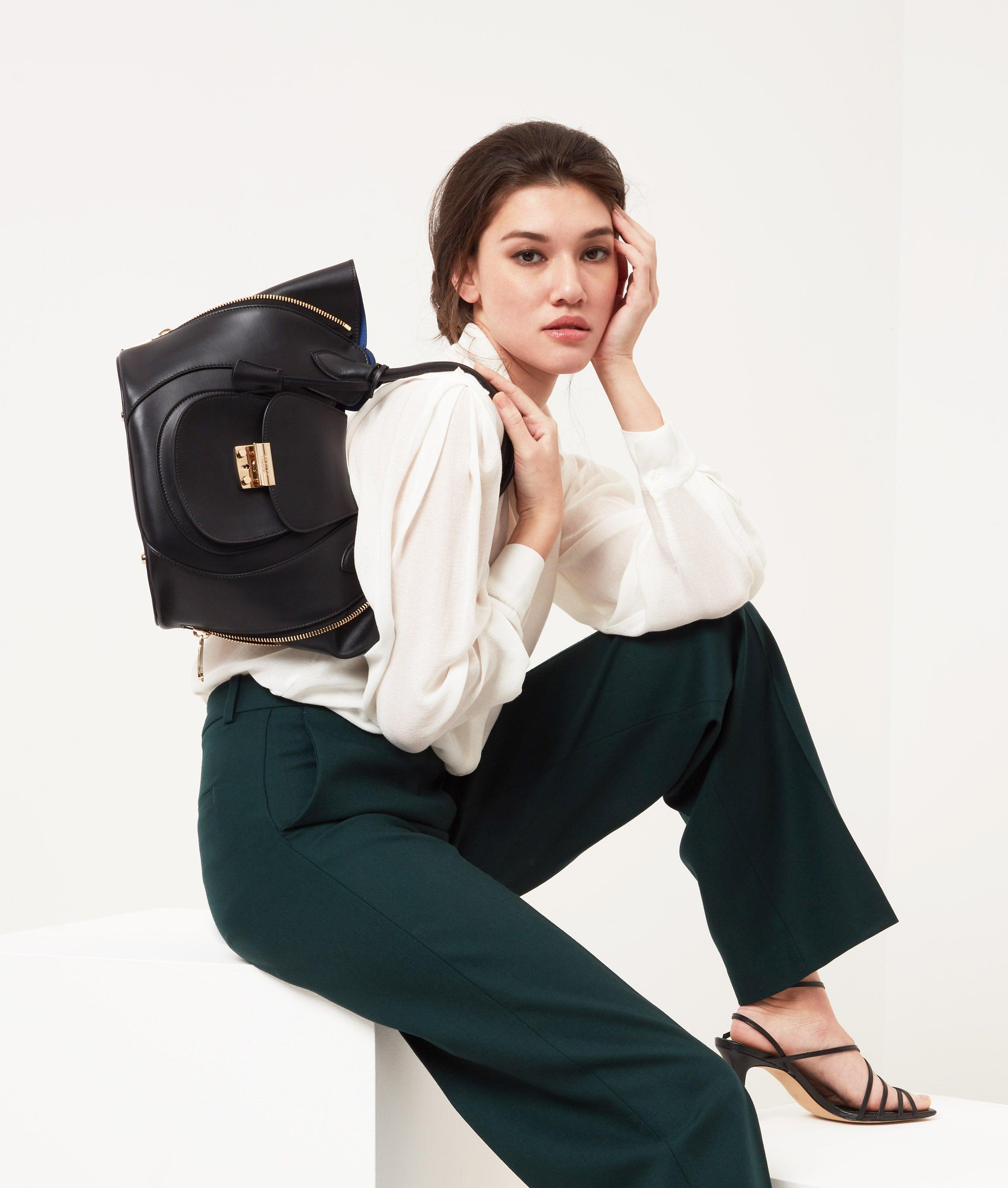 Black Leather Luxury Designer Bag with Blue Suede Lining - Fusion of London's style and Italian craftsmanship.